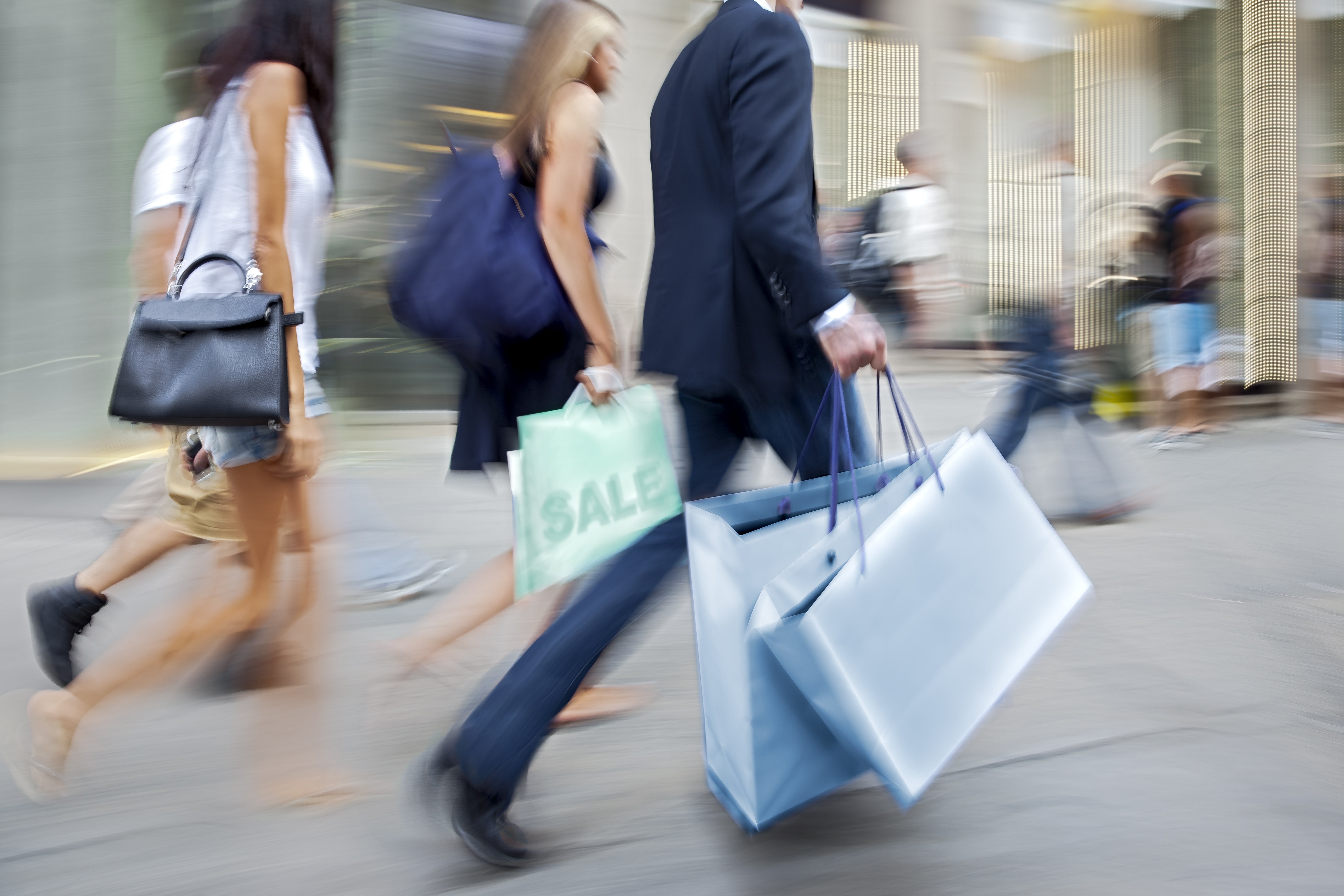 People in the street with shopping bags