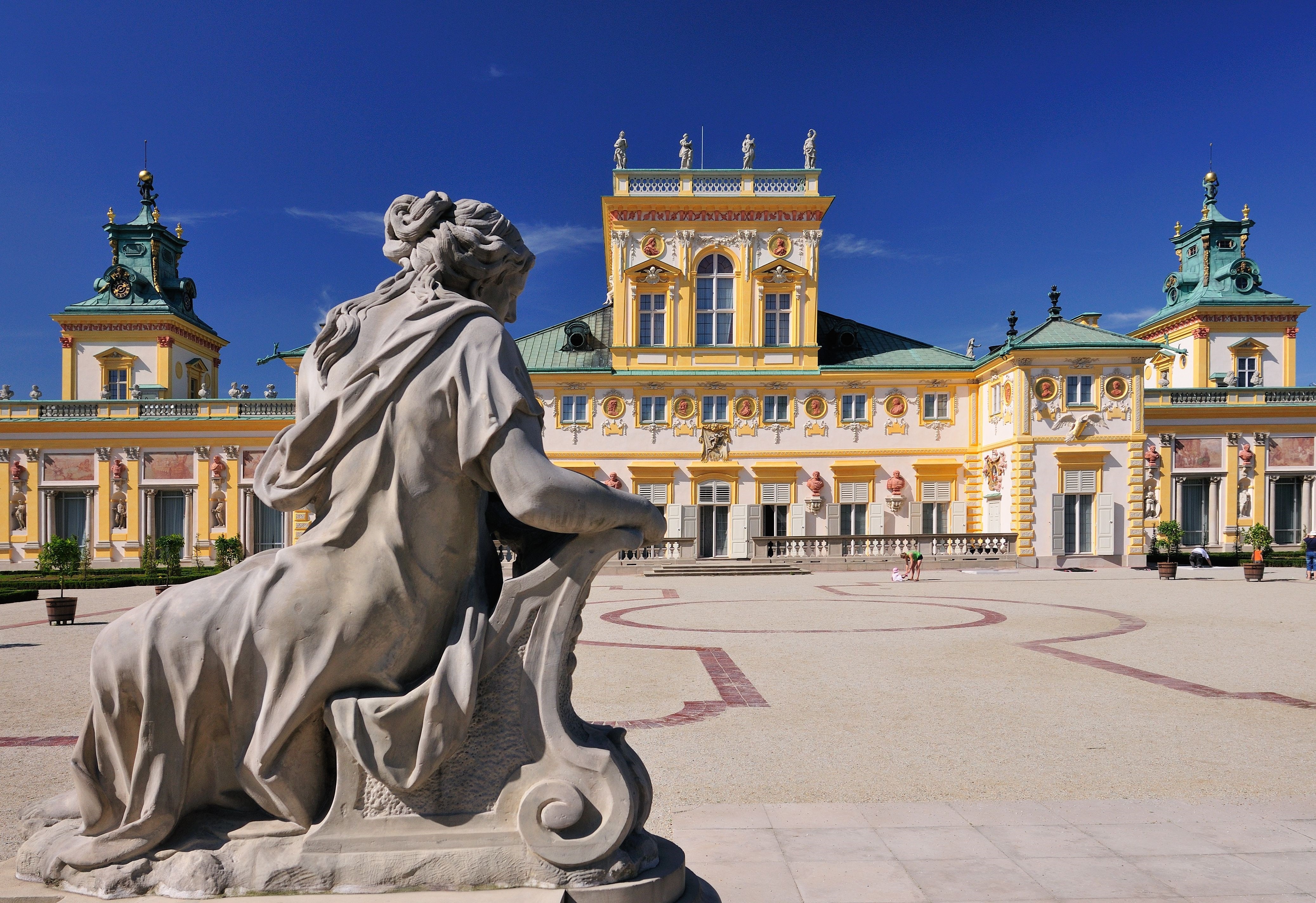 statue in front of an ornate palace
